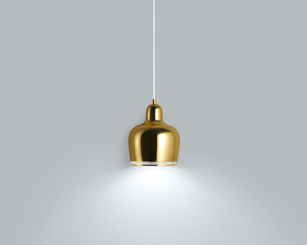 Product image of brass Artek Pendant Light A330S “Golden Bell” with a white cord. The pendant light is switched on and photographed against a grey background.