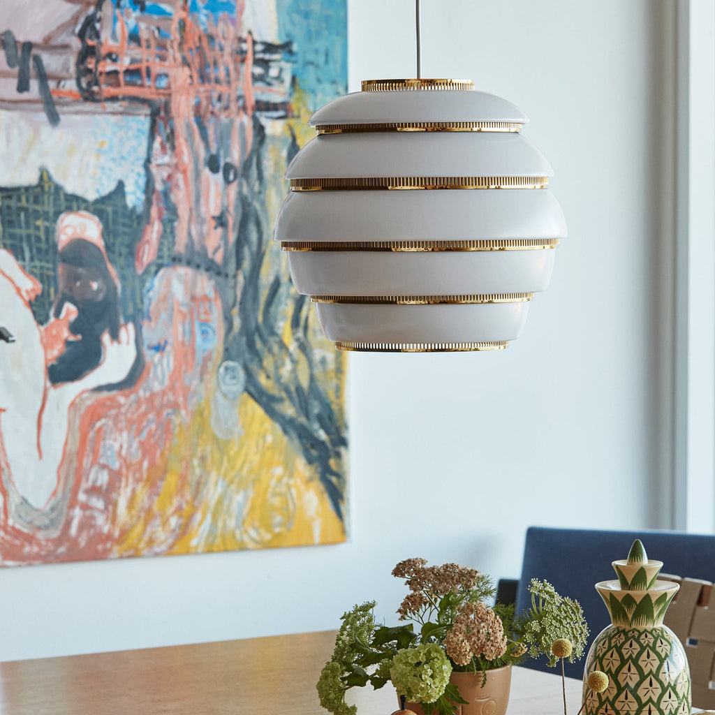 Interior view featuring Pendant Light A331 “Beehive” switched off. A colourful artwork is visible in the background.