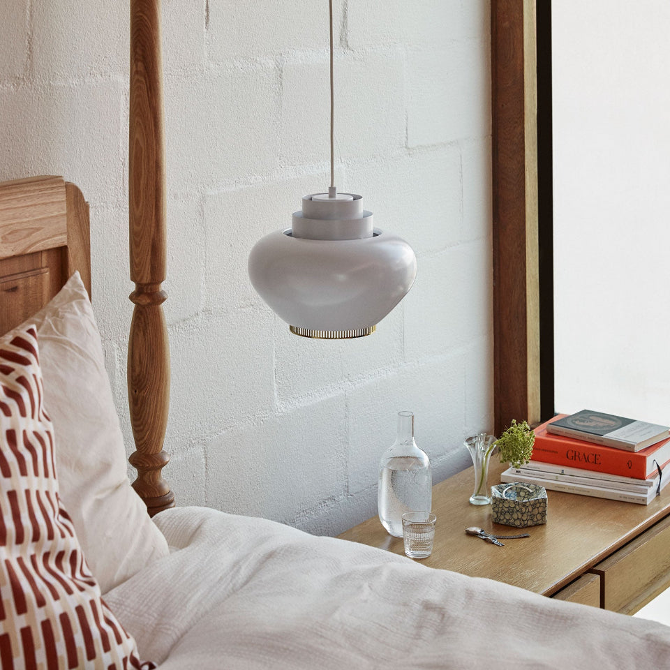Pendant Light A333 “Turnip” hanging above a bedside table in a bedroom. The pendant light is switched off.