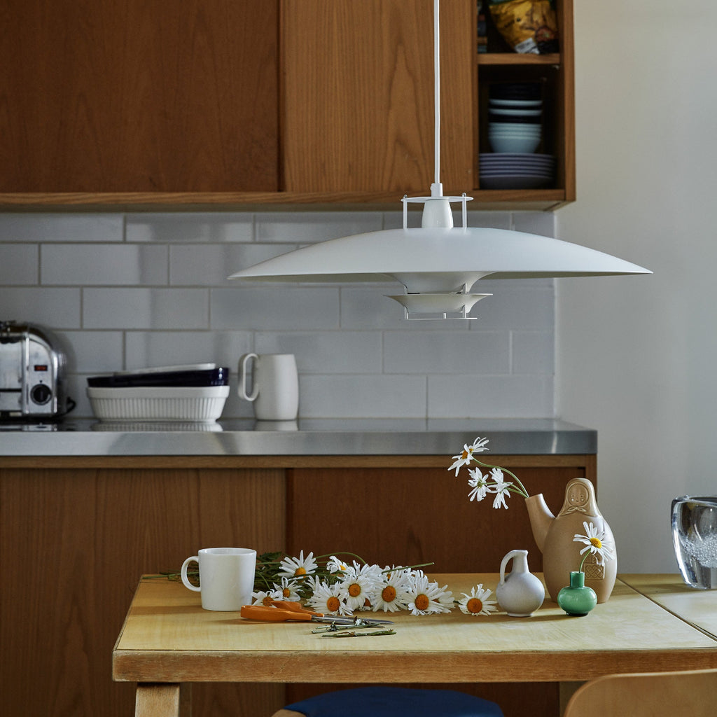 Interior view of a kitchen featuring white Pendant Light JL341 placed above an old table.