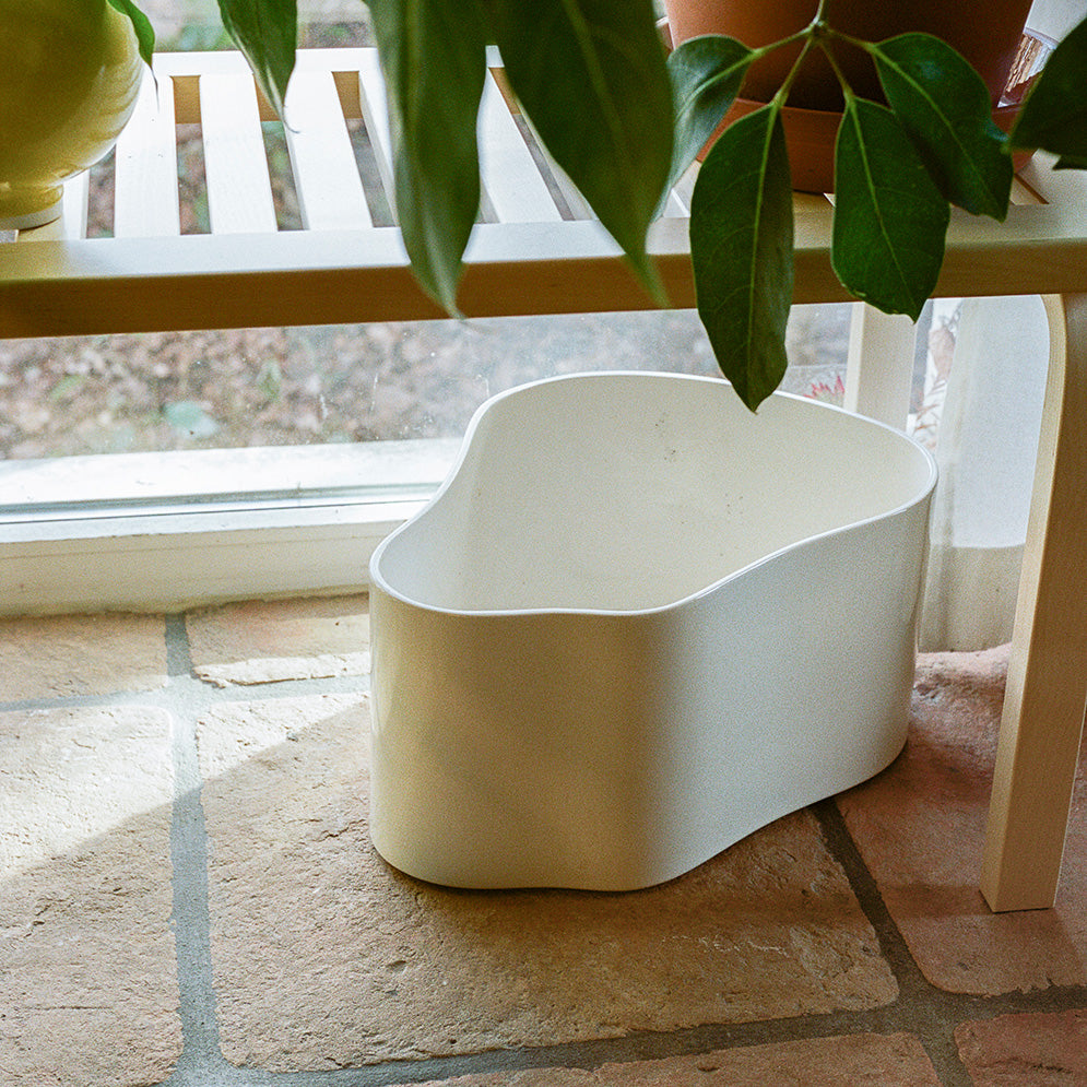 Interior view featuring Riihitie Plant Pot A Large in white placed underneath Bench 153A with slatted top.