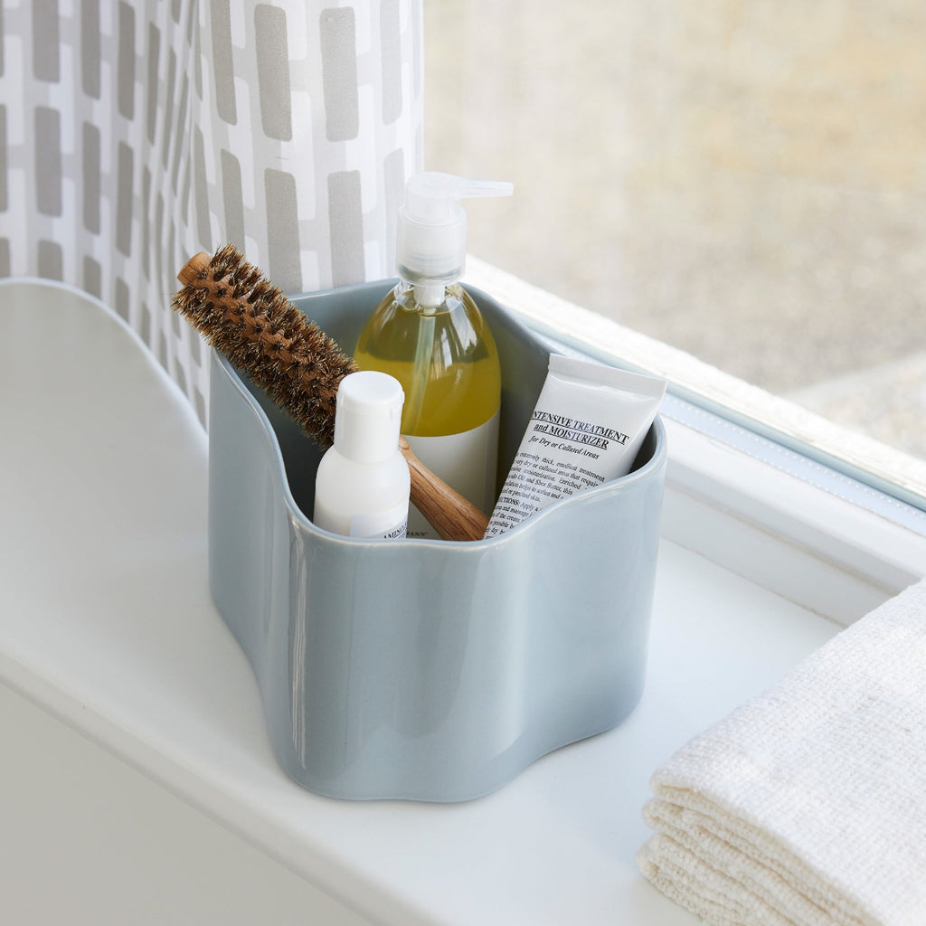 Close-up interior view featuring Riihitie Plant Pot B Small in light grey filled with a hairbrush and other beauty products.