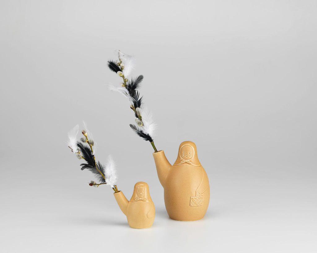 Product image of two Artek Secrets of Finland vases, Easter Witch Vase and Easter Dog Vase, placed side by side against a grey background.