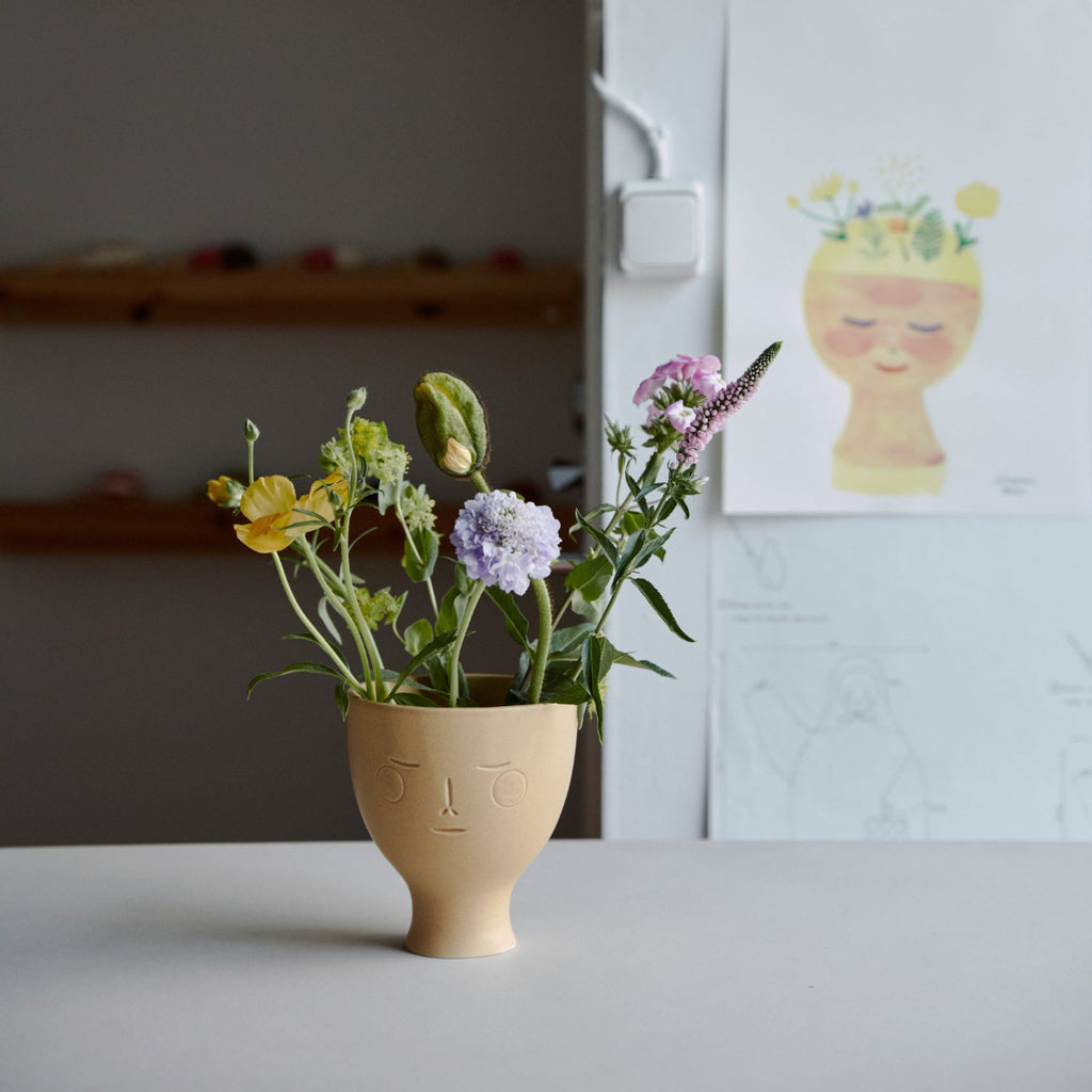 Workspace view featuring Secrets of Finland Midsummer Dream Vase placed on a table with flowers inside. A sketch of the vase is visible in the background.