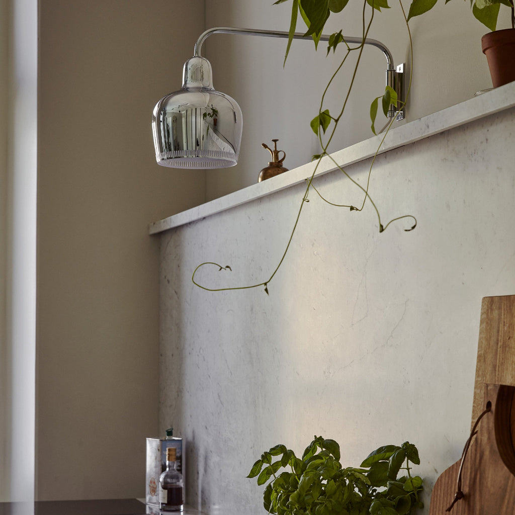 Interior view of a kitchen featuring chrome Wall Light A330S mounted above a marble worktop. The light is switched off.