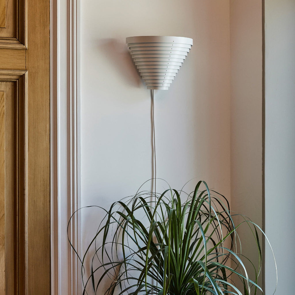 Interior view featuring Wall Light A910 mounted on a hallway wall near a door. The light is switched off.
