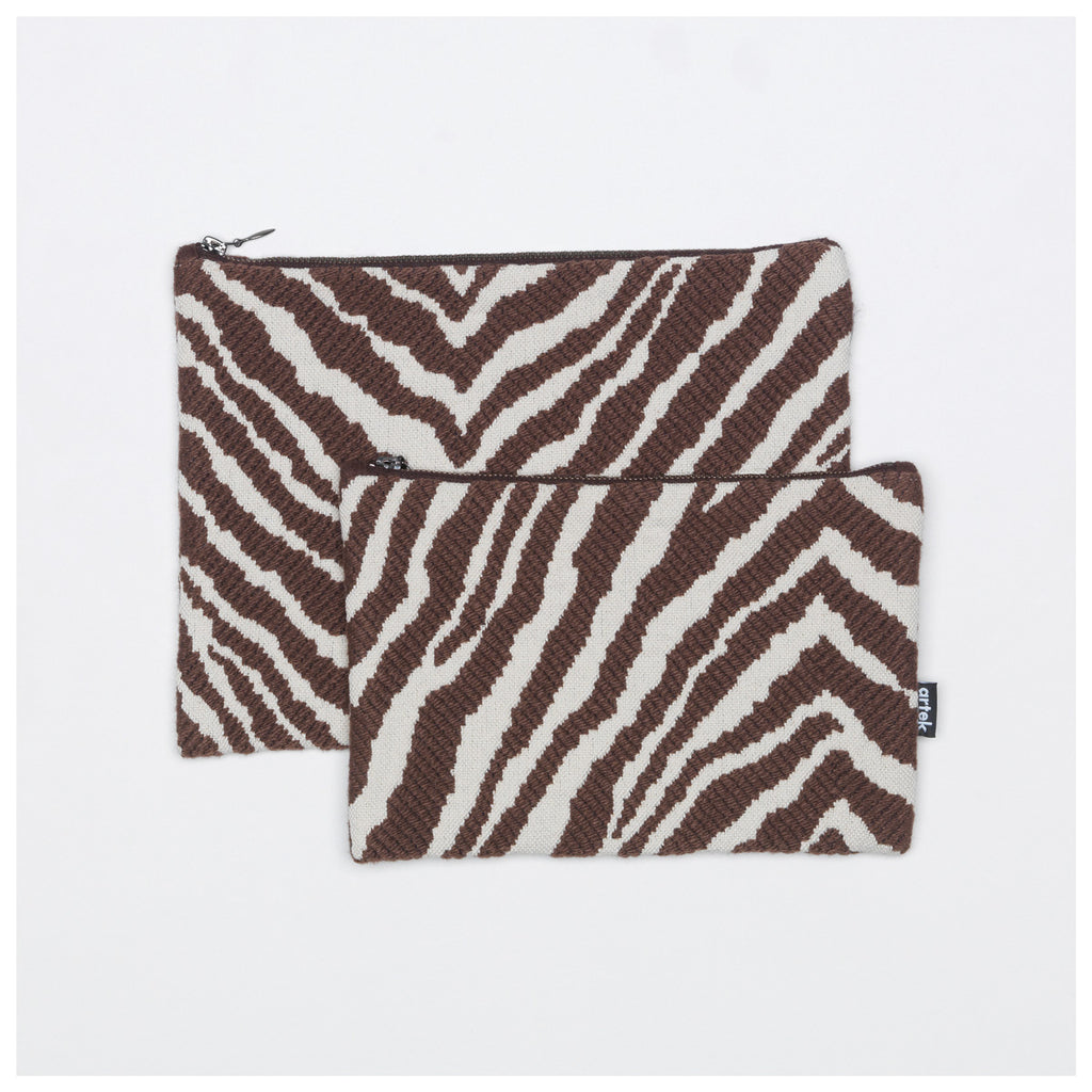 Product image of brown and white Zebra pouches. The smaller pouch is placed partially on top of the larger pouch.